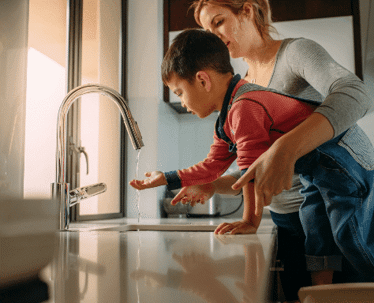woman and son washing hands